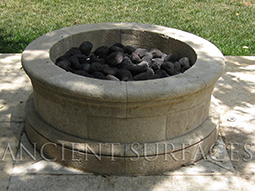 An arched stone fireplace surround carved by hand